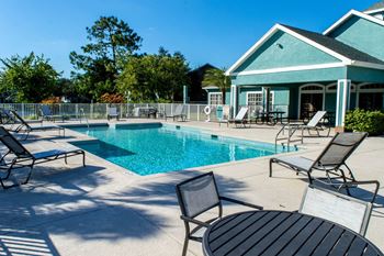 Sparkling outdoor swimming pool with relaxing sundeck
